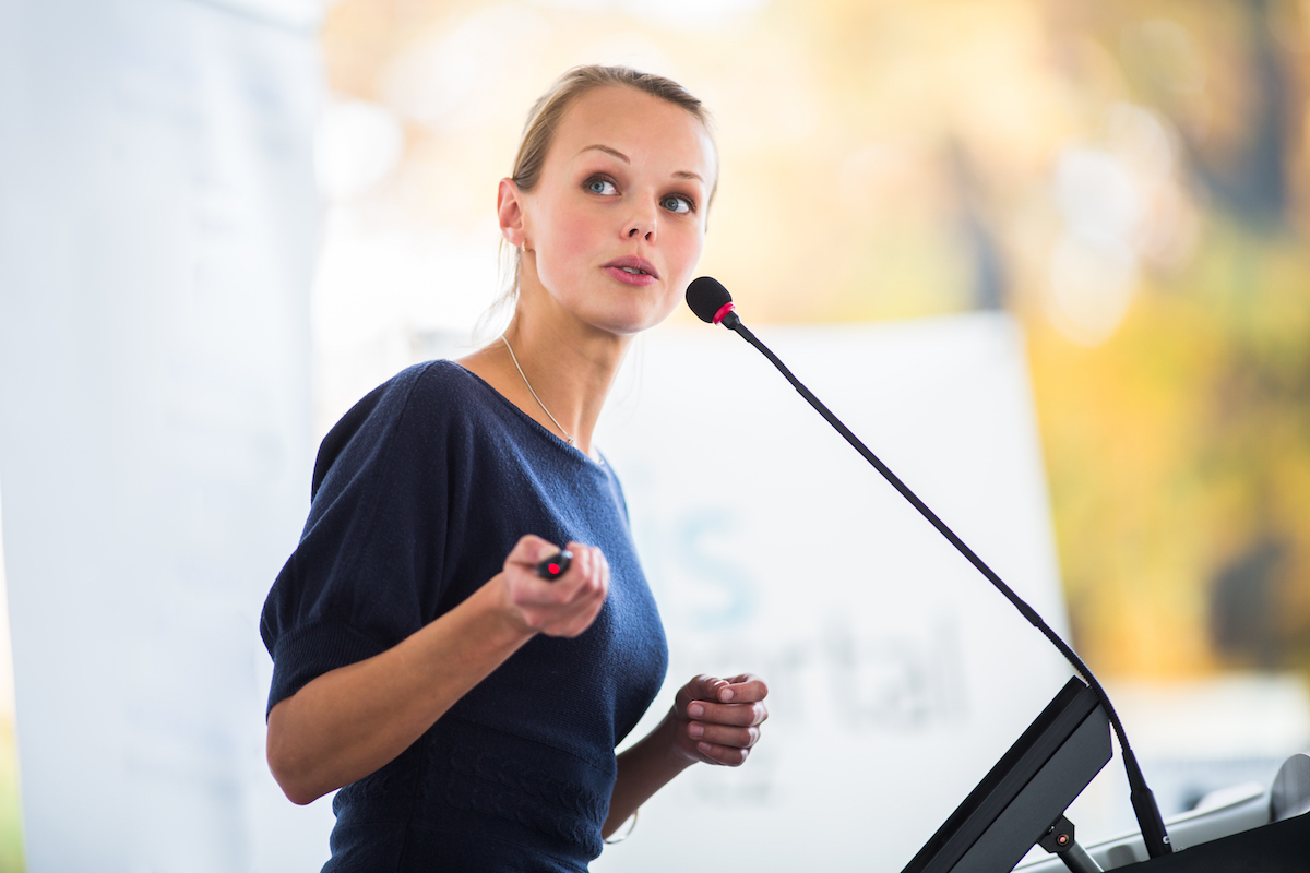 Young woman speaking at a customer experience conference
